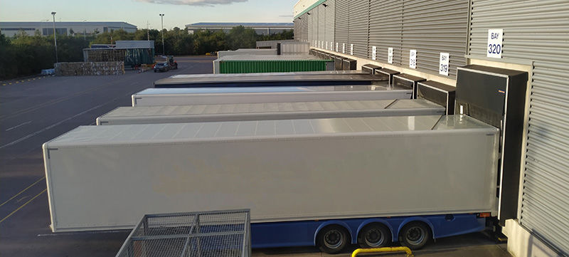 trailers and containers outside a warehouse with reserve stock